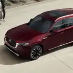 2026 Mazda CX-90 for Uniondale NY area drivers, dark red SUV seen from above parked on a stone plaza