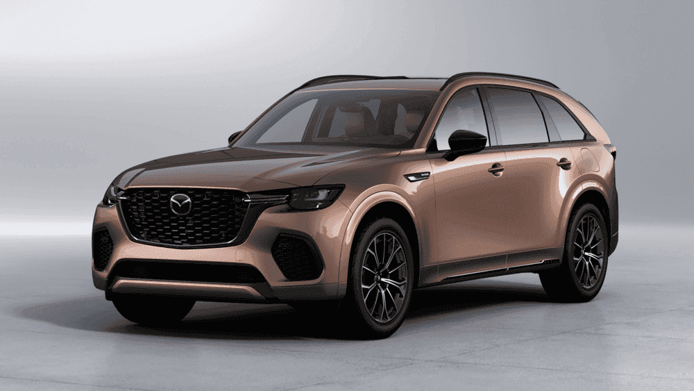 2026 Mazda CX-70 near Hempstead NY, bronze SUV with black grille and dark alloy wheels on a plain studio background