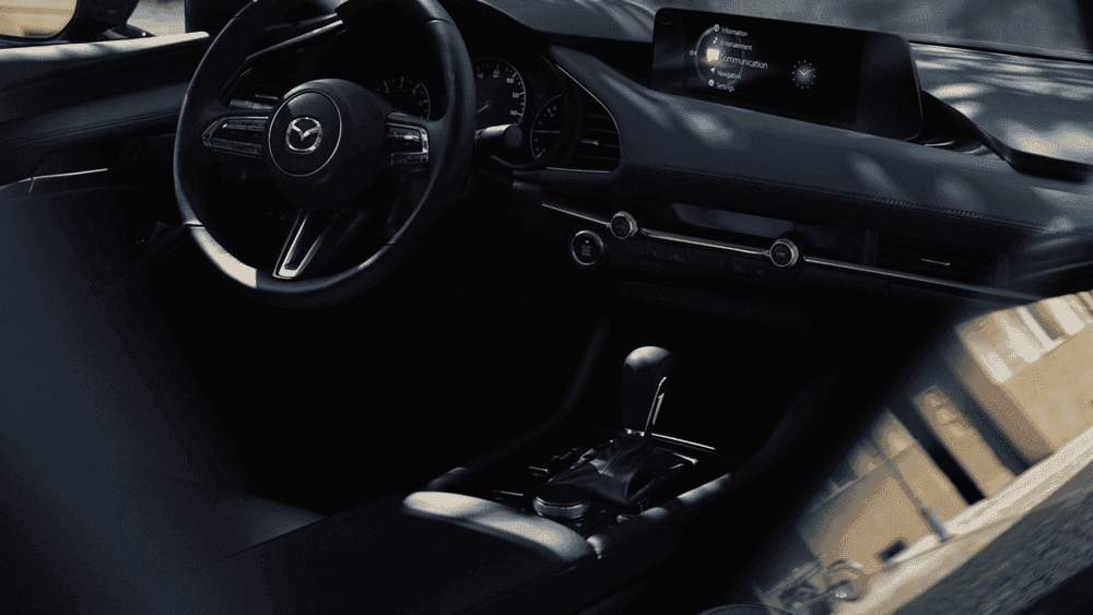 2026 Mazda3 Hatchback near Hempstead NY, black interior with Mazda steering wheel, infotainment screen, and automatic gear selector