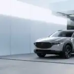 2026 Mazda CX-30 near Hempstead NY, silver SUV parked outside a modern home with a black entry door and glass facade