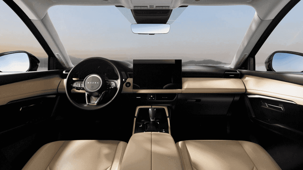 2026 Mazda CX-5 tan leather interior with steering wheel and touchscreen display near Uniondale, NY.