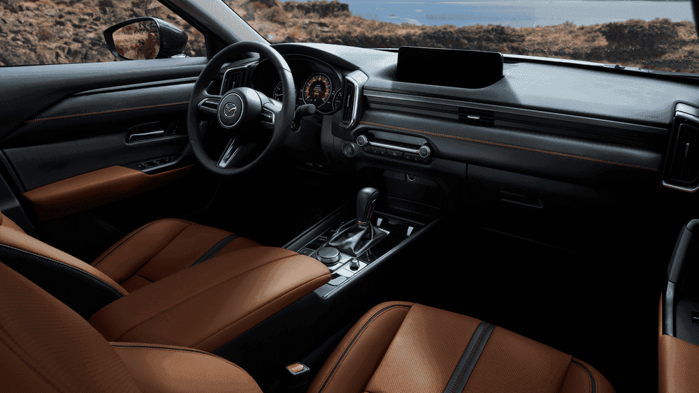2026 Mazda CX-50 tan leather interior with black dashboard near Uniondale, NY.