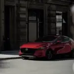 2026 Mazda3 Hatchback in red parked on a city street near Uniondale, NY.