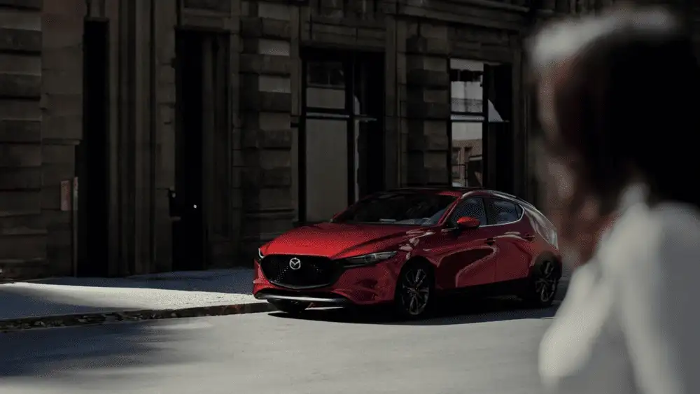 2026 Mazda3 Hatchback in red parked on a city street near Uniondale, NY.