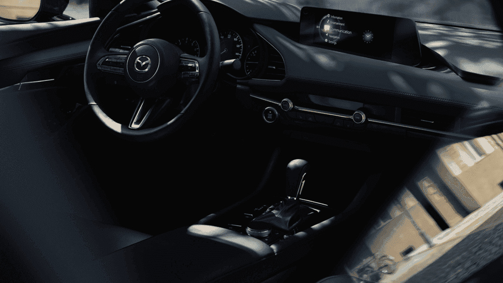 2026 Mazda3 Hatchback black interior with steering wheel and touchscreen near Uniondale, NY.