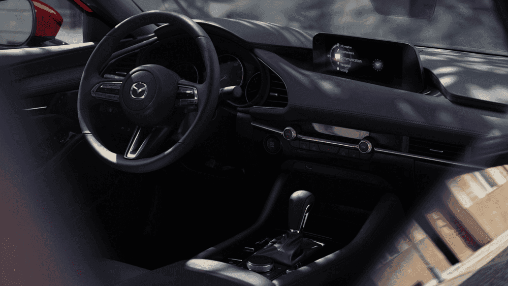 2026 Mazda3 Sedan black leather interior with steering wheel and display near Uniondale, NY."