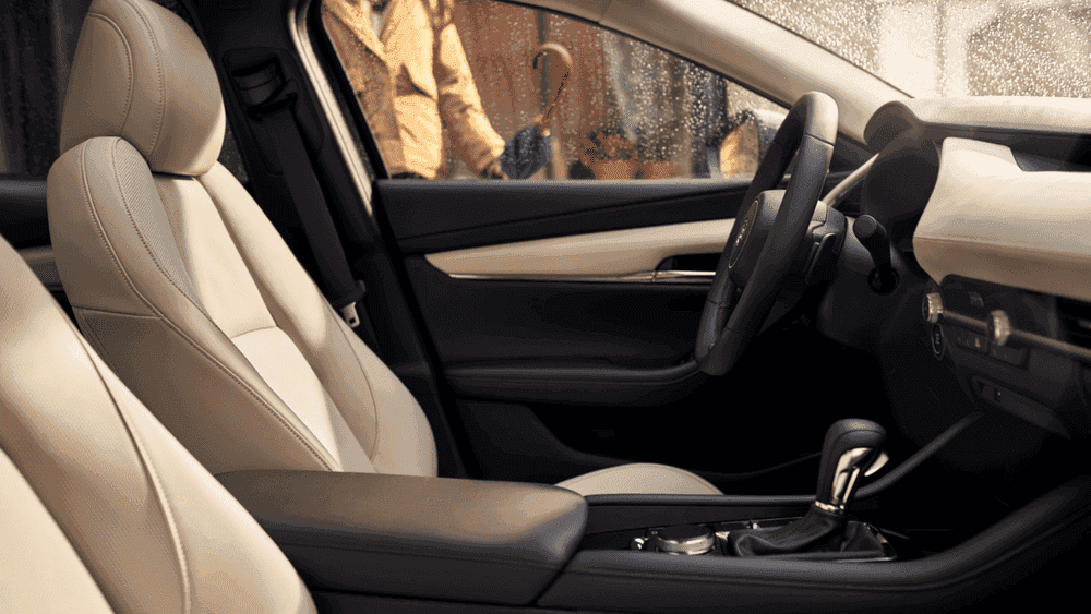2026 Mazda3 Sedan cream leather front seats and dashboard near Uniondale, NY.