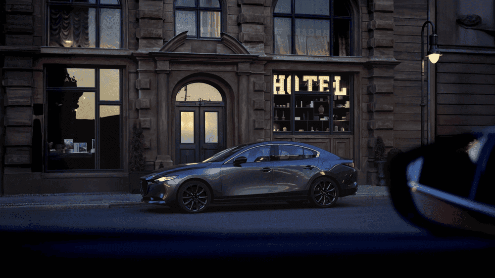 2026 Mazda3 Sedan in gray parked on city street at dusk near Uniondale, NY.