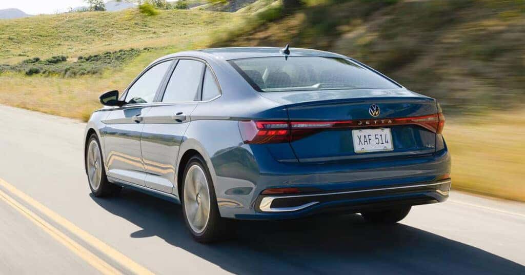 2026 Volkswagen Jetta driving on a scenic highway