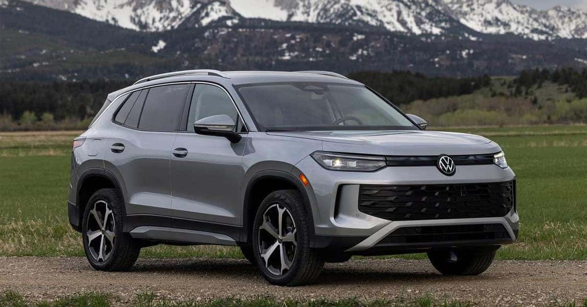 2026 Volkswagen Tiguan SUV in silver, shown from the front three-quarter view on a gravel road