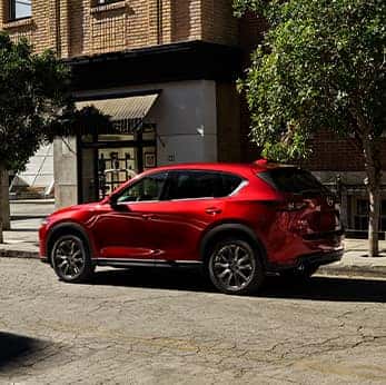 Lancaster Mazda is a Mazda Dealership near  East Petersburg, PA | Red CX-5 in downtown shopping plaza