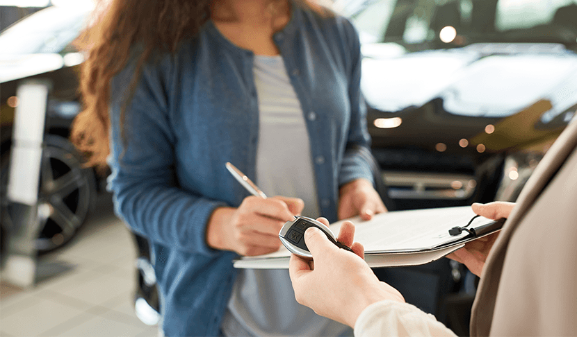 Why drivers should consider an extended warranty on their Mazda at Lancaster Mazda | Man giving new car keys to customer at a dealership