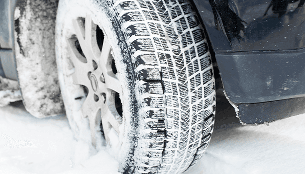 How to prepare your Mazda for the winter season in East Petersburg, PA at Lancaster Mazda | Close up detail of car tire covered in snow 