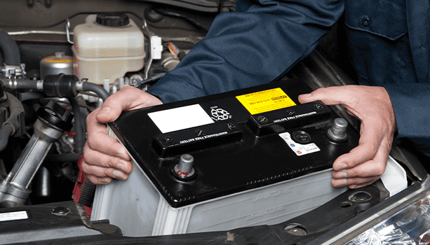 How to prepare your Mazda for the winter season in East Petersburg, PA at Lancaster Mazda | Mechanic installing new car battery for car 