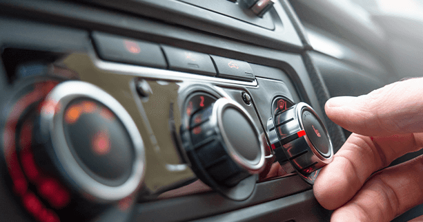 How to prepare your Mazda for the winter season in East Petersburg, PA at Lancaster Mazda | Person turning temperature knob to warm up the car