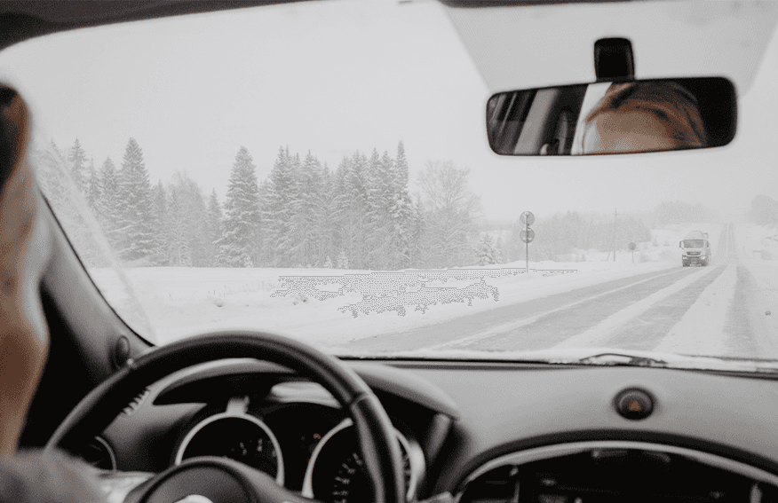 How to Prevent your Vehicle from Fogging Up At  Lancaster Mazda in East Petersburg, PA | Woman driving her car in the middle of a snow storm while another car is driving on the opposite side of the road