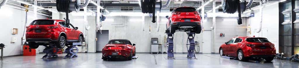 Brake replacement and Safety at Lancaster Mazda | Mazda garage with multiple red color Mazda vehicles