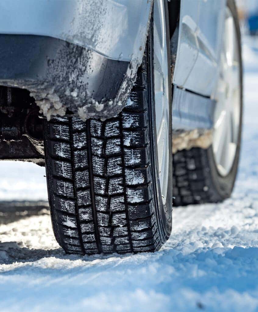 Winter Tires vs. All Season Tires at Lancaster Mazda in East Petersburg, PA | Close of a car with winter tires in the snow