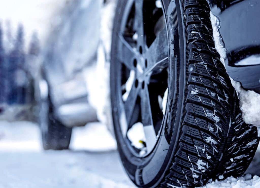 Winter Tires vs. All Season Tires at Lancaster Mazda in East Petersburg, PA | Close up of a car with all season tires in the snow