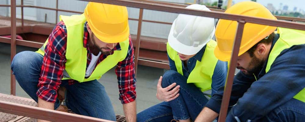 Three construction workers working