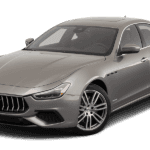 A taupe Maserati Ghibli against a white background.