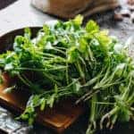 Fresh parsley and cilantro on wooden table