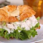 Closeup of a chicken salad and lettuce on a croissant roll