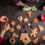 Little girls making Christmas gingerbread cookies.
