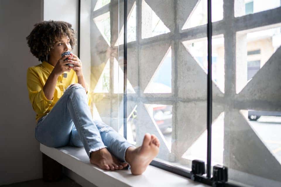 A young woman drinking coffee on a calm morning