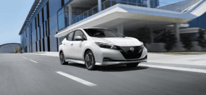 white nissan driving on road