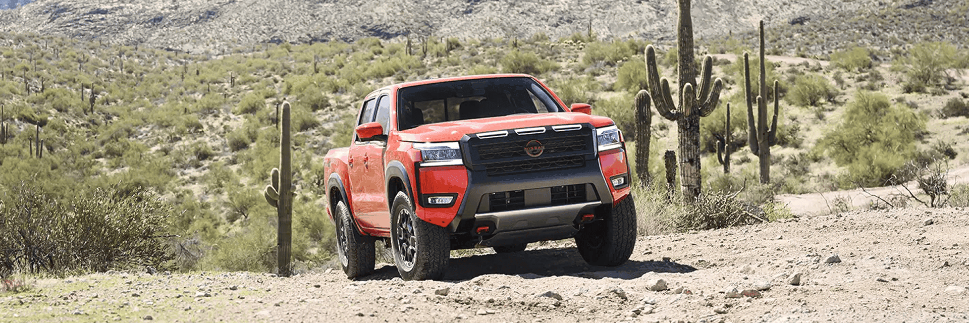 red 2026 nissan frontier parked in desert
