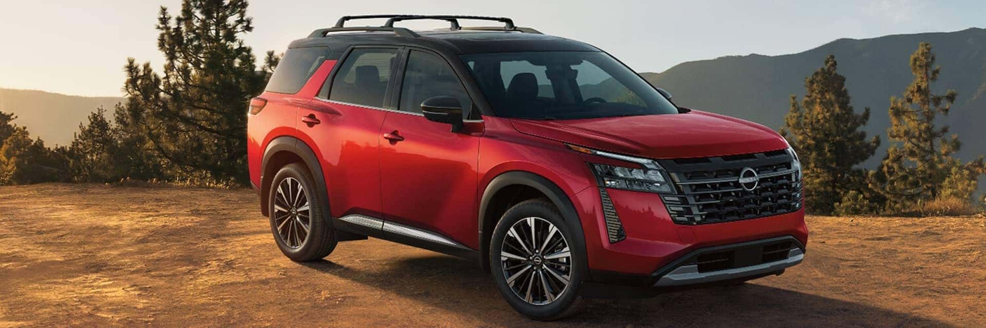 red nissan pathfinder parked in sand