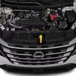 Car battery inspection under the hood during extreme summer heat in Tampa, Florida