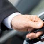 Close up of man's hand opening a car door