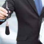 man handing over car keys