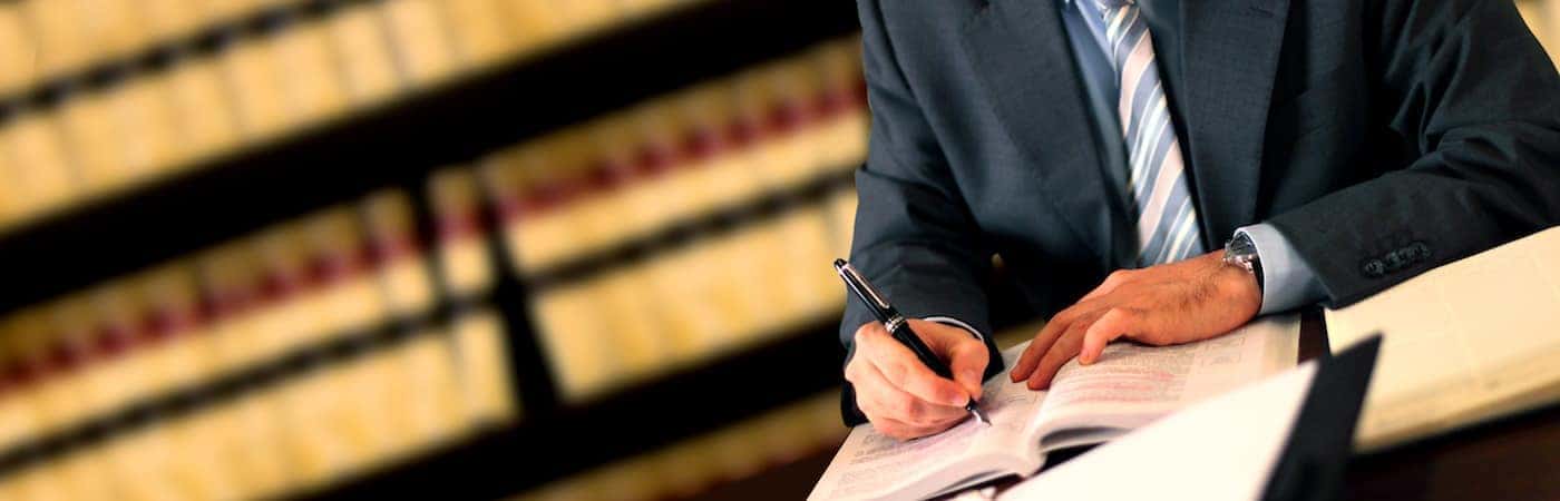 Man Writing in Book