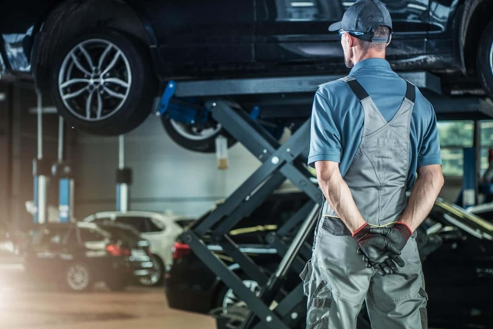 Mechanic replacing low engine coolant. 