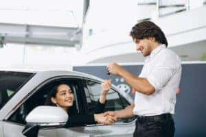 Woman leasing a new Hyundai at car dealership in Denver, CO. 