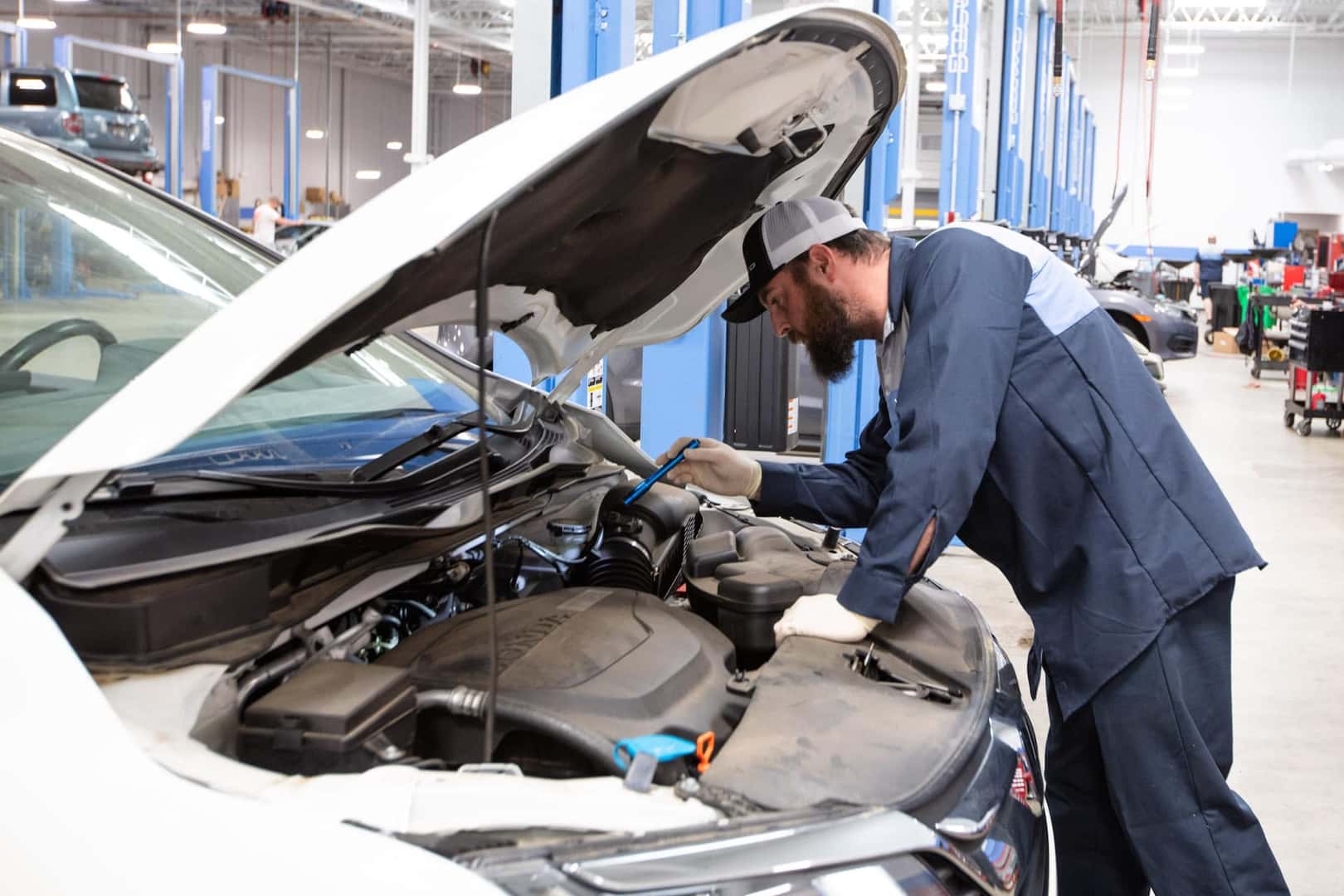 Service Tech checking engine with engine checker.