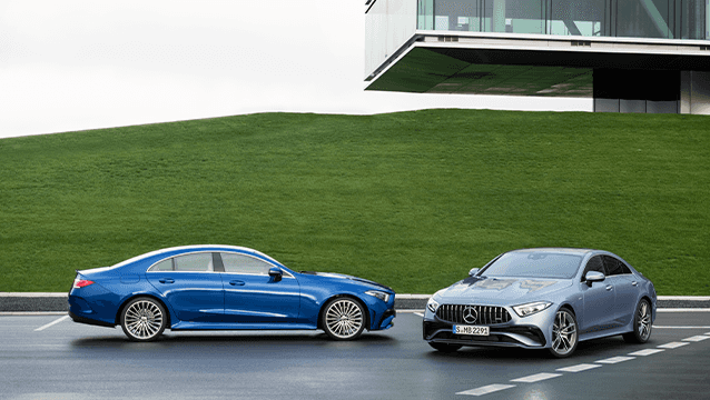 Mercedes-Benz CLS sedan and Mercedes-AMG CLS parked outside a Mercedes-Benz facility