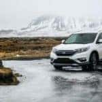 white Honda SUV on gray floor