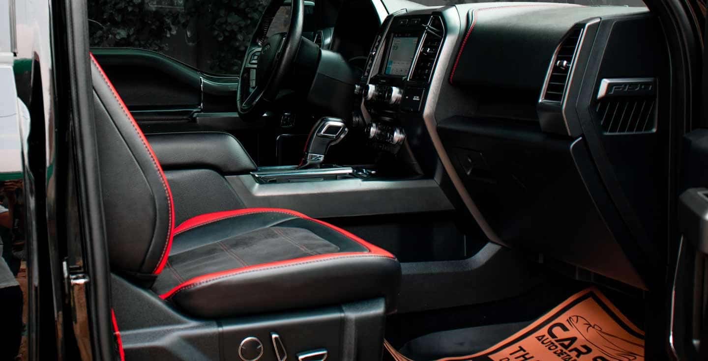 Interior of a vehicle with red seat belt among used cars for sale near Philadelphia, PA