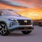 Used Hyundai Tucson SUV parked outdoors, showcasing its sleek design and durability, against the backdrop of a stunning sunrise.