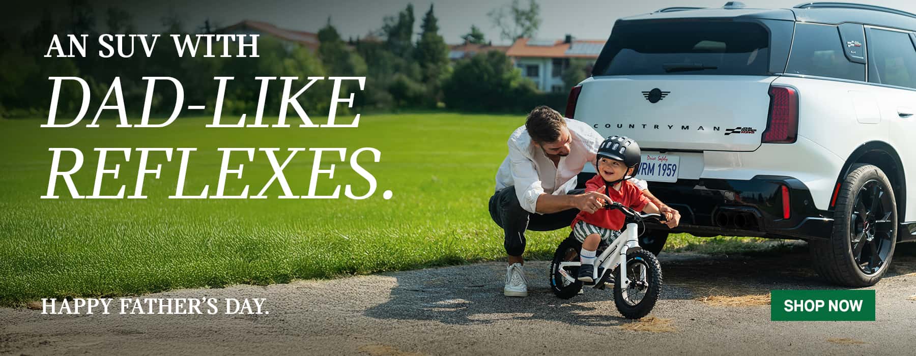 Back View of MINI Countryman with Dad and Son on Bike.