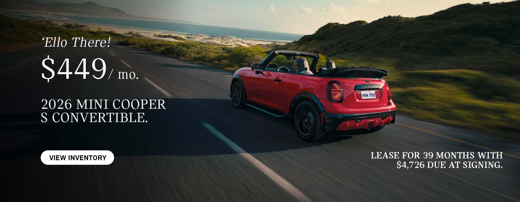 MINI convertible cruising down road.