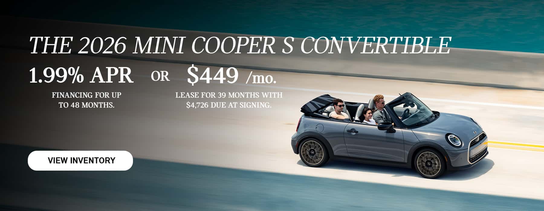 Gray MINI Convertible driving across a bridge.