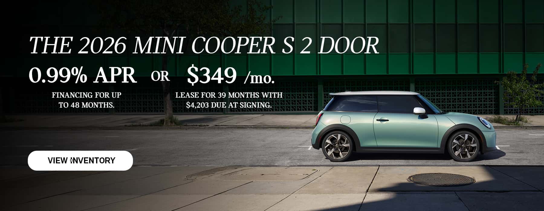 Green MINI 2 Door parked in front of a green building.
