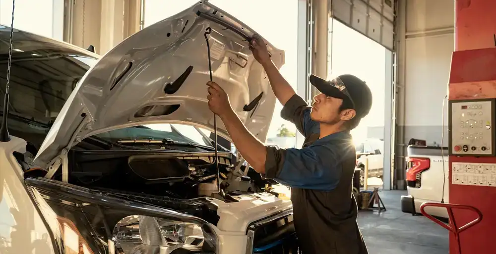Mechanic performing a used truck inspection
