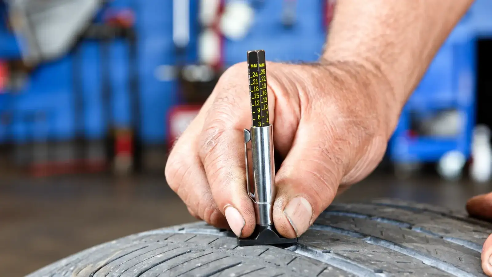 Measuring tread depth and checking tire wear on a used truck