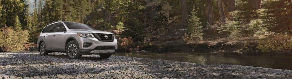 2020 Nissan Pathfinder silver driving through creek